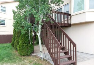 This picture shows the 3'-wide open stairs with wood railing that were removed when we built the new deck.