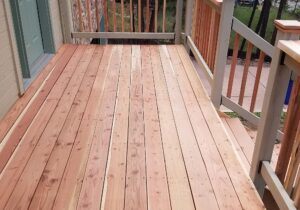 This beautiful redwood deck features a snow fence railing with a drink cap and post caps.