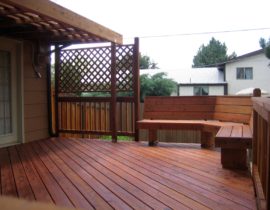 A Heart redwood deck with the boards at a 45-degree angle. We also added a few custom built extras - a rough-sawn cedar pergola, lattice work above part of the railing, and a built-in bench on one corner.