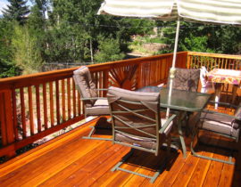We built this redwood deck that features a custom designed wood railing. It is a snow fence railing, but with a design in the middle panel that was make to look like a sunrise.