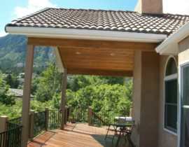 This gabled deck cover was built over a deck done in Massaranduba hardwood. The cover has a vaulted ceiling in tongue and groove with recessed lights. In order to make the new deck cover look original, we used tile roofing to match the rest of the house.