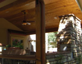 An amazing outdoor living space that has a gabled deck cover with vaulted tongue and groove ceiling that features recessed lights and a ceiling fan. We also built a stone, wood-burning fireplace.