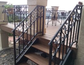 Custom designed and built, powder coated, wrought iron railing installed between stucco columns.