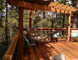 B-grade redwood deck with the boards laid at 90-degrees. We also built a tri-corner cedar pergola in one corner of the deck.