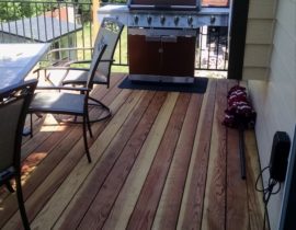 We built this B-grade redwood at 90-degrees to the joists. The railing has wood posts with post cap and metal rail panels between the posts.