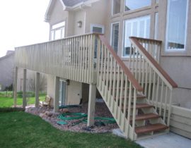This deck has a redwood picket fence railing with a drink cap which was stained in a contrasting color.