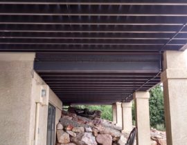 The underside of a deck built with powder coated steel deck framing.