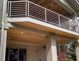 This deck has a white metal railing with horizontal balusters for a unique look.