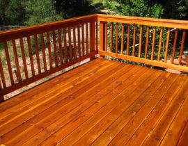 A cedar deck with snow fence railing and drink cap