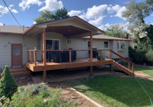 Gorgeous Redwood deck with gabled deck cover and custom designed wood and steel cable railing.