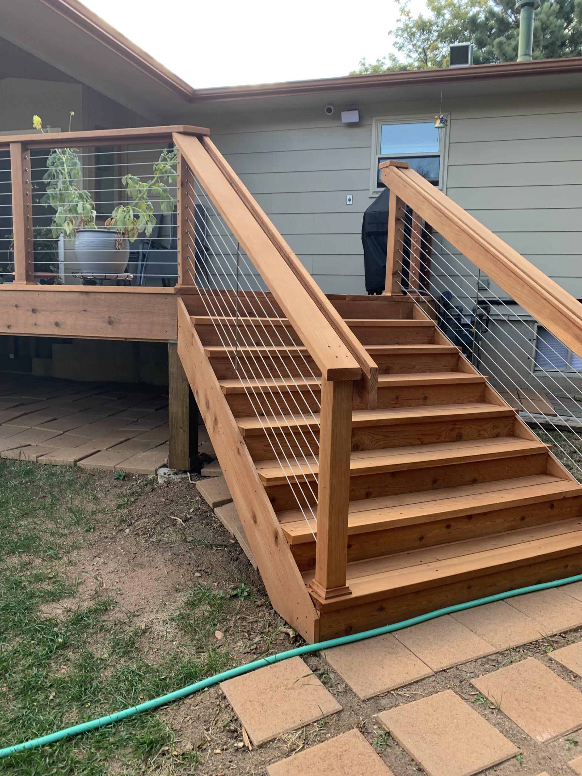 Deck stairs that are 6'-wide with closed steps and a custom railing.
