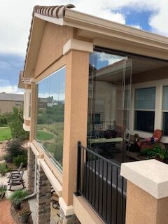 Sliding glass doors allow access to the uncovered portion of the deck from the 3-season room.