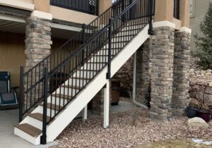 Braced deck stairs with black, metal panel railing and handrail