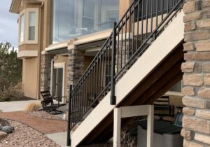 Braced deck stairs with metal panel railing.
