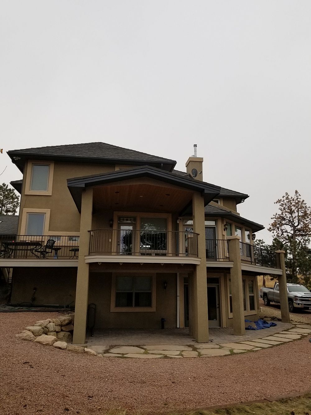 Large composite deck with gabled deck cover and stucco columns