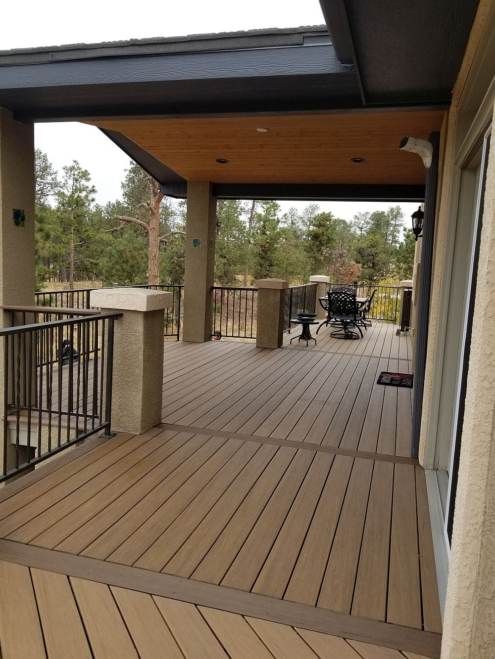 Composite decking laid at 90-degrees to the joists with a picture frame border and divider boards.