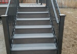 4'-wide, closed composite steps with a composite and metal panel railing.