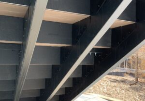 The underside view of steel framed deck stairs.