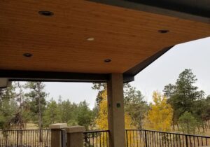 The underside of a gabled deck cover showing the vaulted, tongue and groove ceiling with recessed lighting