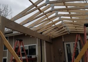The trusses being installed for the gable deck cover.