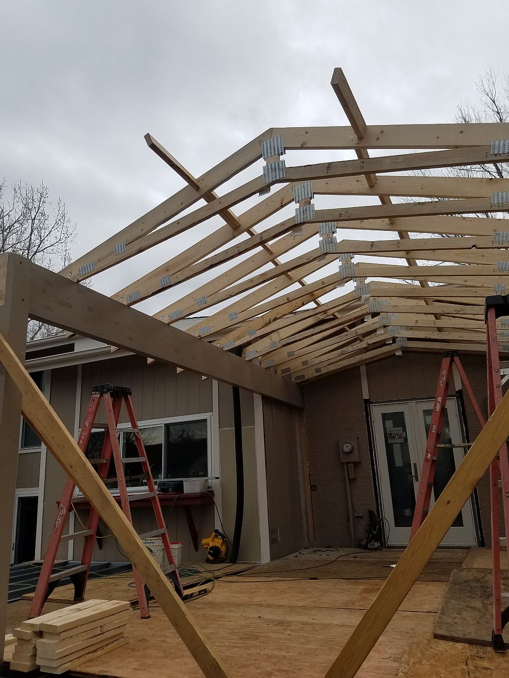 The framing for a gabled deck cover