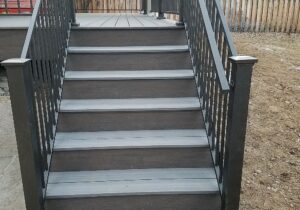 The stairs were built with a handrail along the railing for safety