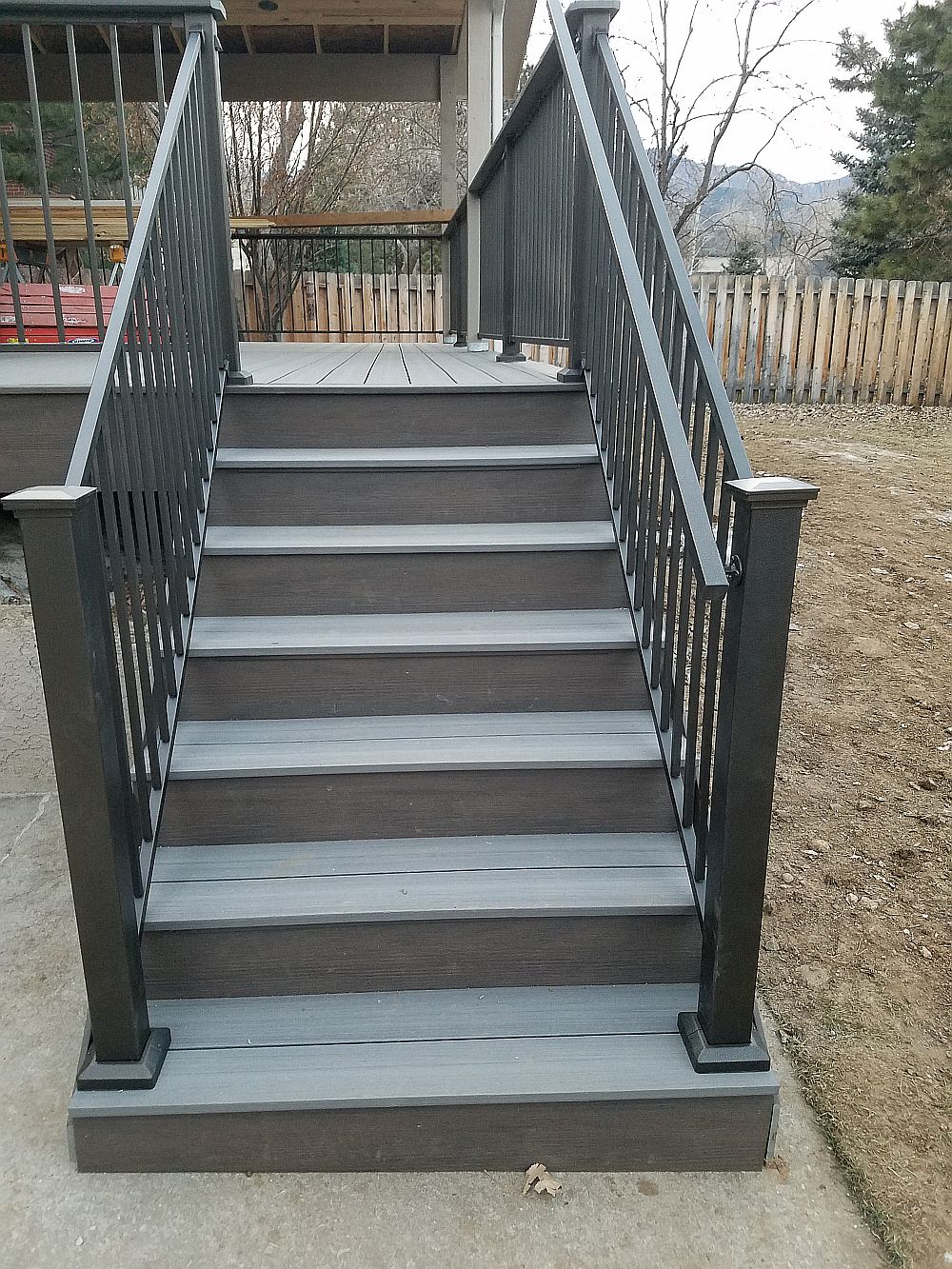 Composite deck stairs with metal panel railing and handrail