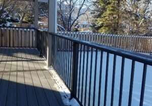 Metal panel deck railing with composite drink cap installed.
