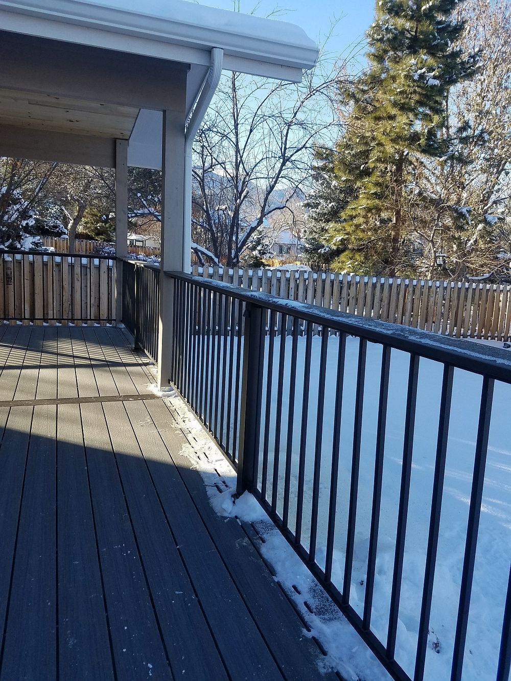 Fortress Fe26 metal panel deck railing with 3x3 posts and round metal balusters