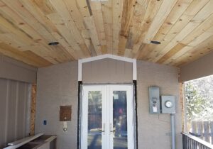A close up of the Blue Stain pine, tongue and groove ceiling with recessed lighting