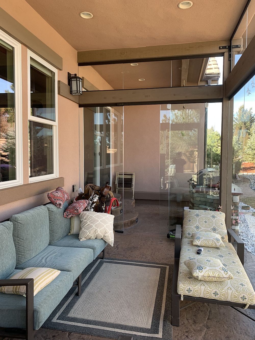 Covered patio turned into full-use 3-season room with glass walls and doors.