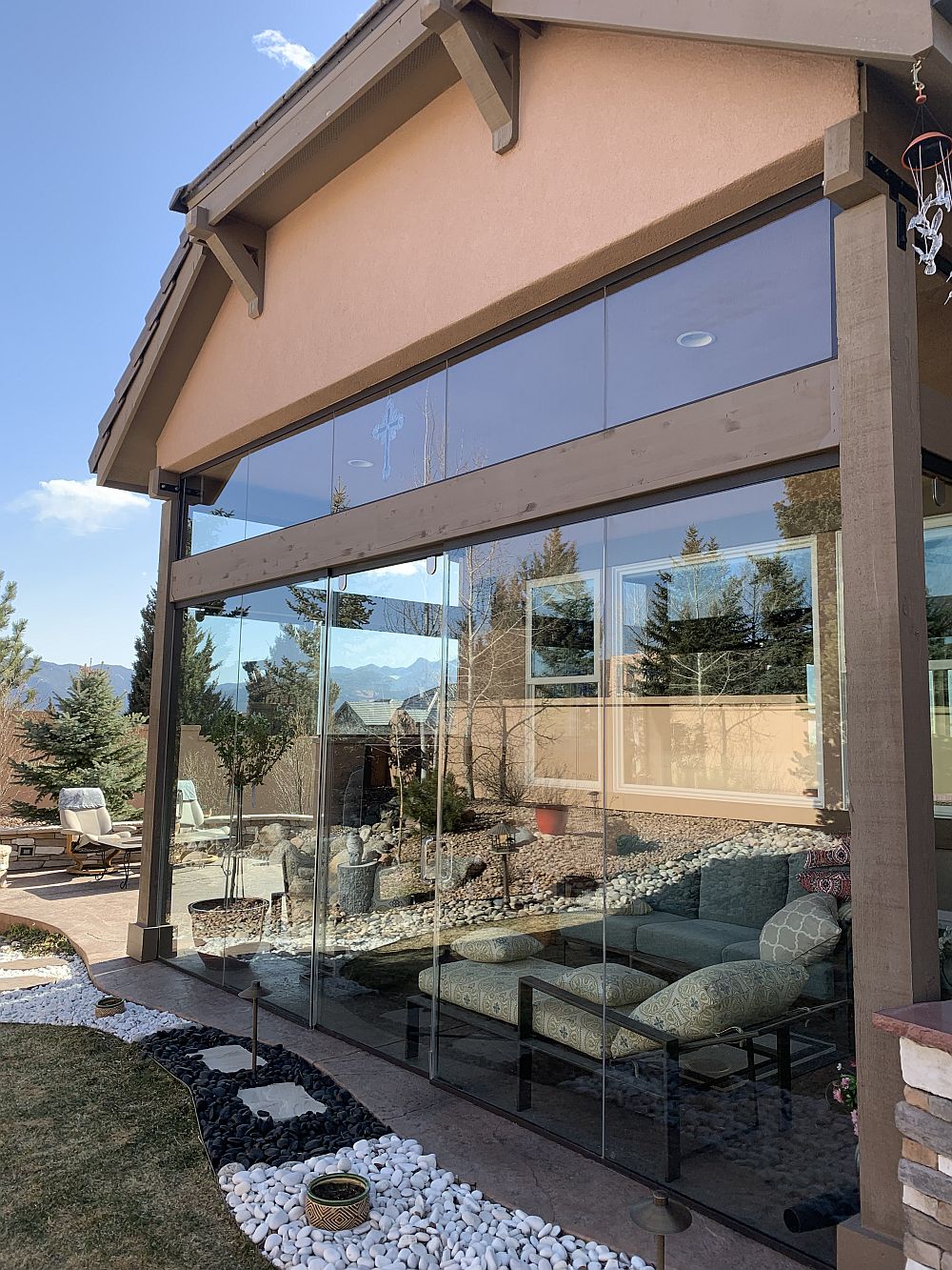 Covered patio turned into 3-season room with glass walls