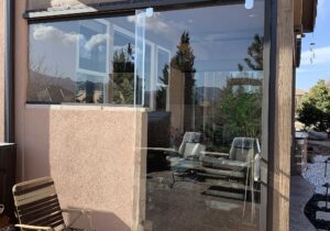 We designed a sliding glass door and glass panel to accommodate an existing stucco half-wall.