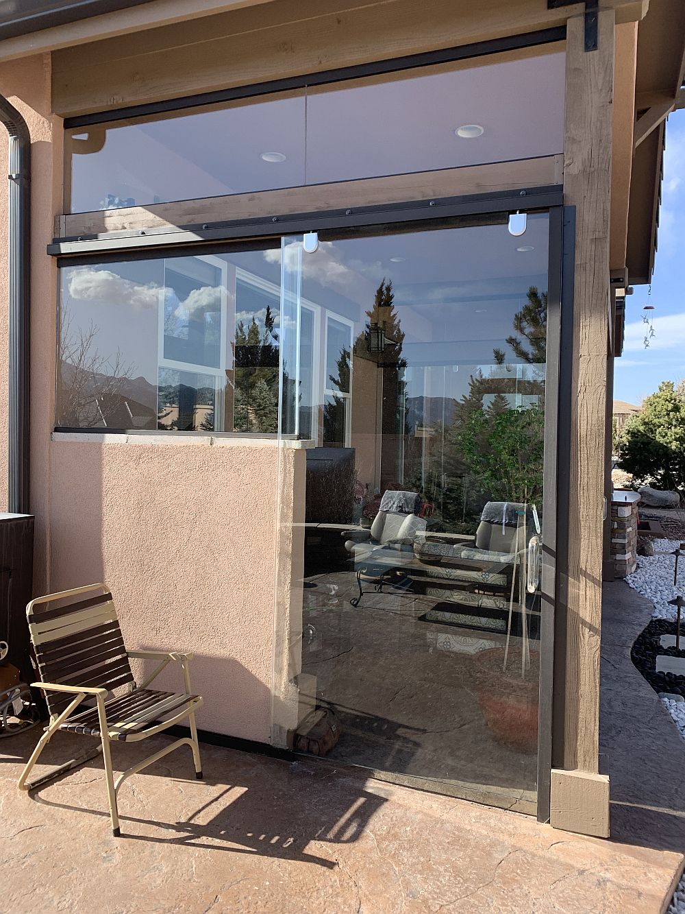 Sliding glass door leading into glass enclosed patio