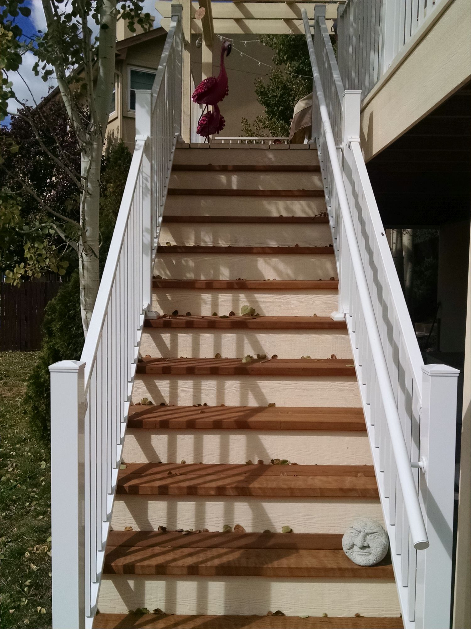 3'-wide closed deck stairs with a white aluminum railing and handrail.