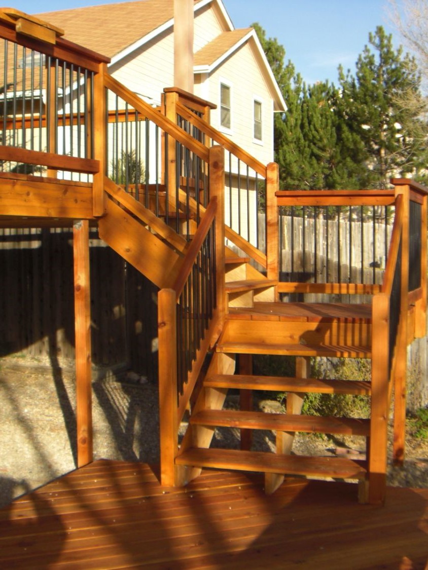 Upper and lower wood decks are connected by 3'-wide open stairs with a 90-degree turn landing.