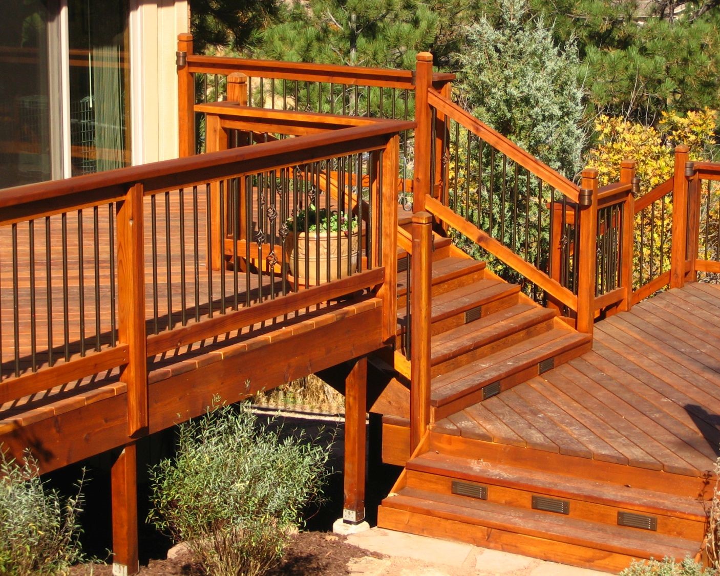 Custom-built, multi-level redwood deck featuring 6'-wide closed steps between the different levels.