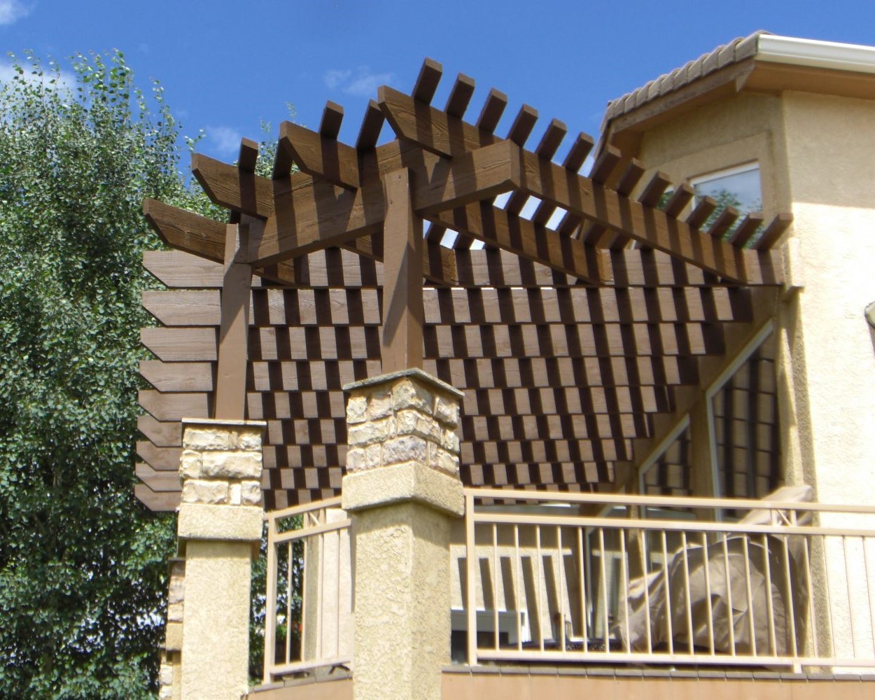 Cedar pergola with a unique angle added to a composite deck