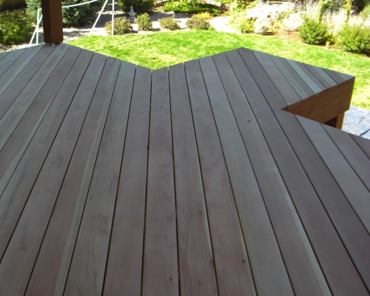 An unstained B-Grade Redwood deck with the boards laid at a 45-degree angle to the joists.