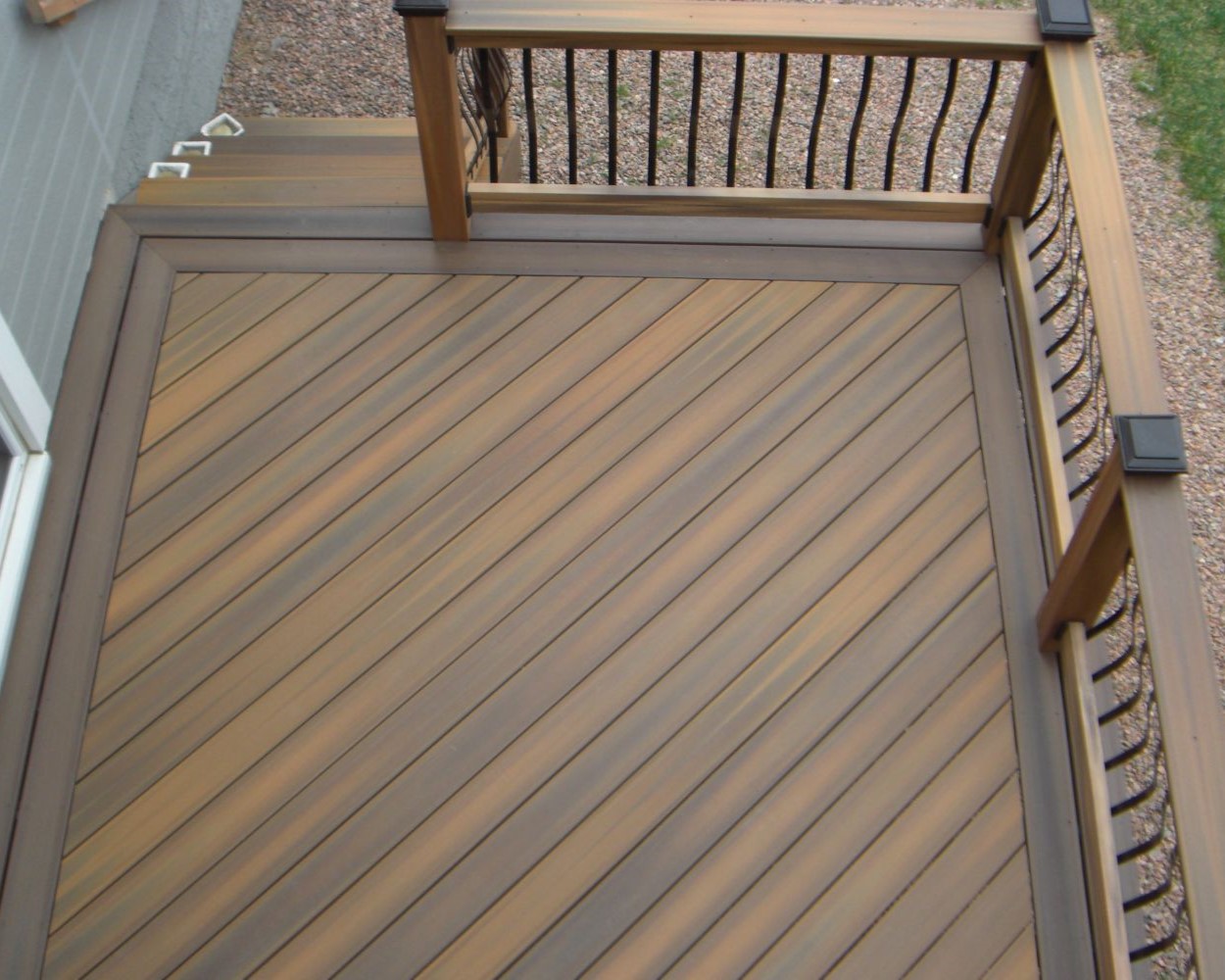 Composite deck with the boards laid at a 45-degree angle and a double picture frame border.