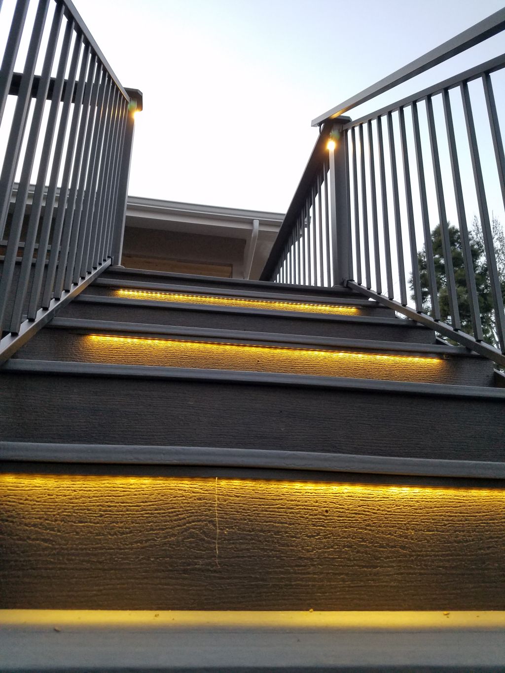 Closed, composite deck stairs that feature a lighted LED strip under each step for night time safety.