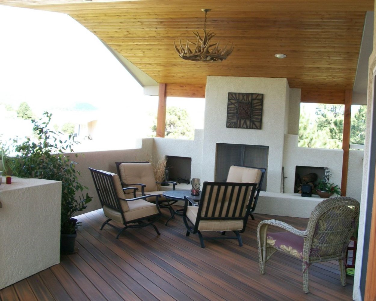 Custom deck built with composite material, features a wood-burning stucco fireplace and gabled deck cover with vaulted tongue and groove ceiling.