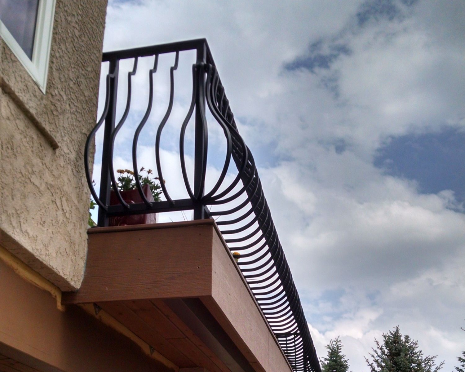 Composite deck with a belly and bow design metal railing.