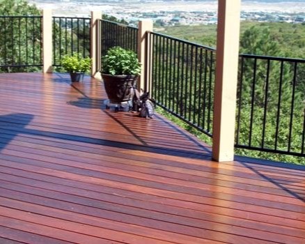 Brazilian Redwood deck with the boards laid at 45-degrees. The metal panel railing system is attached to wood posts