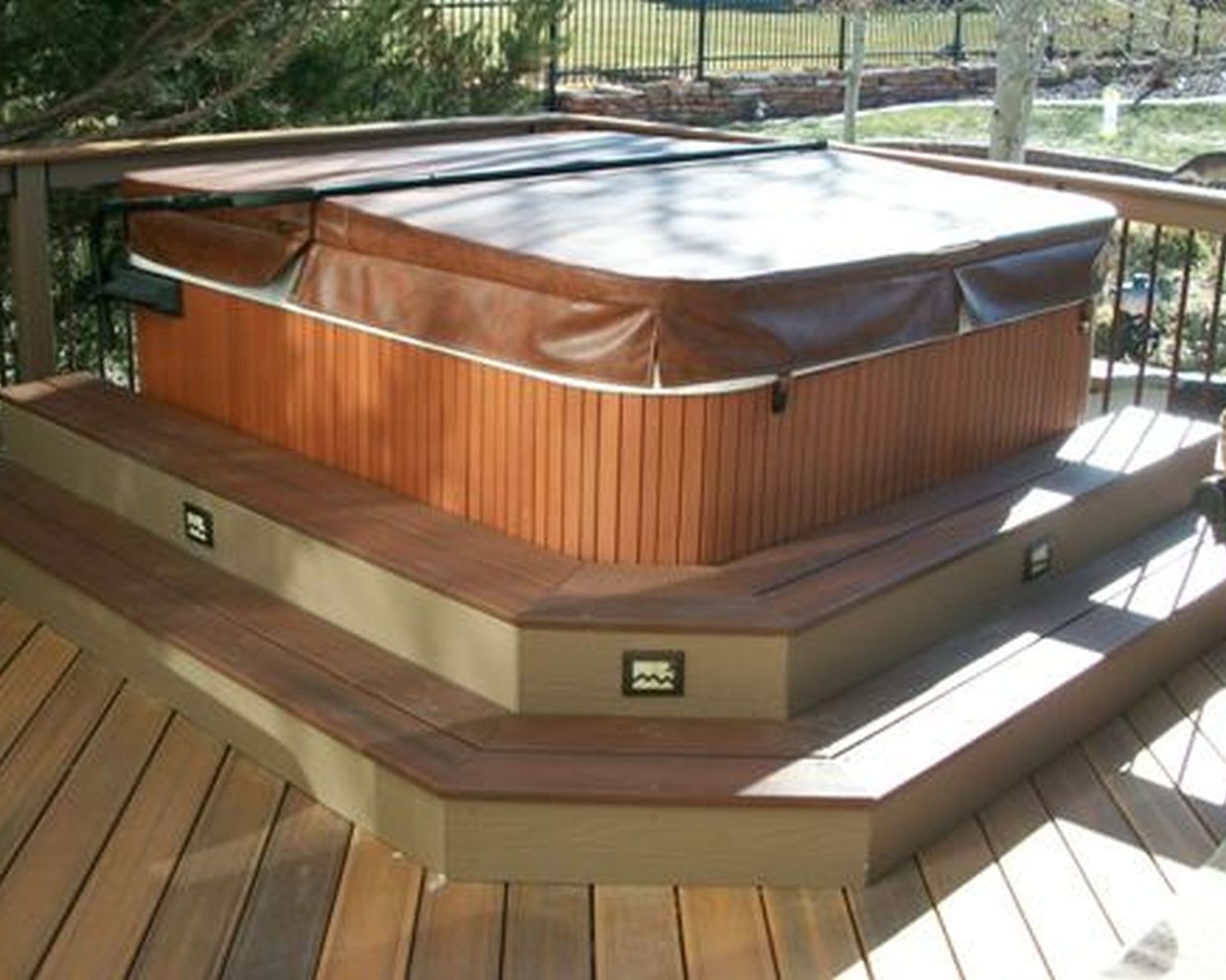 Hot tub with surrounding composite step that feature step lights.