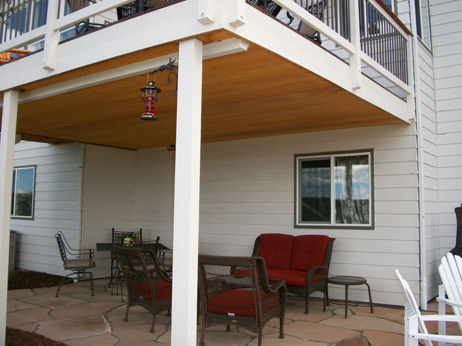 Hardwood deck with an under-deck drainage system that has a flat, tongue and groove ceiling.