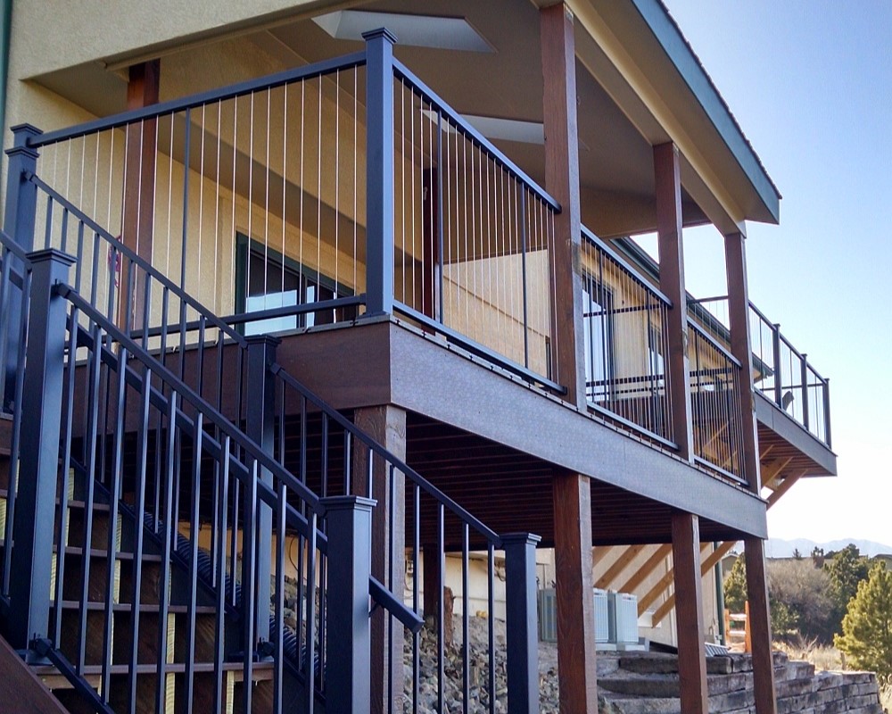Composite deck with cover and a custom metal and stainless steel cable railing.