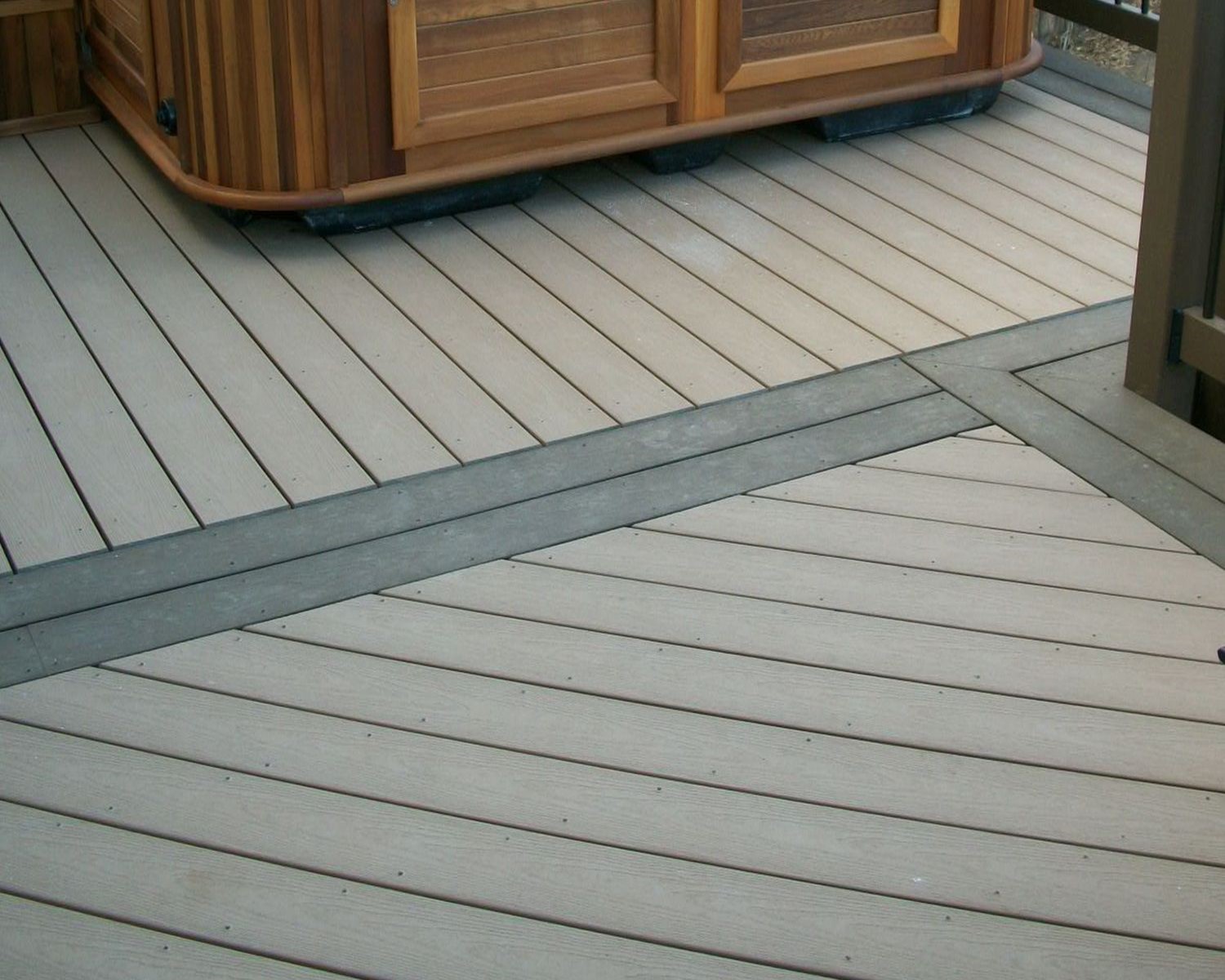 This composite deck is laid out in multiple angles with the double divider boards and picture frame border in a contrasting color.