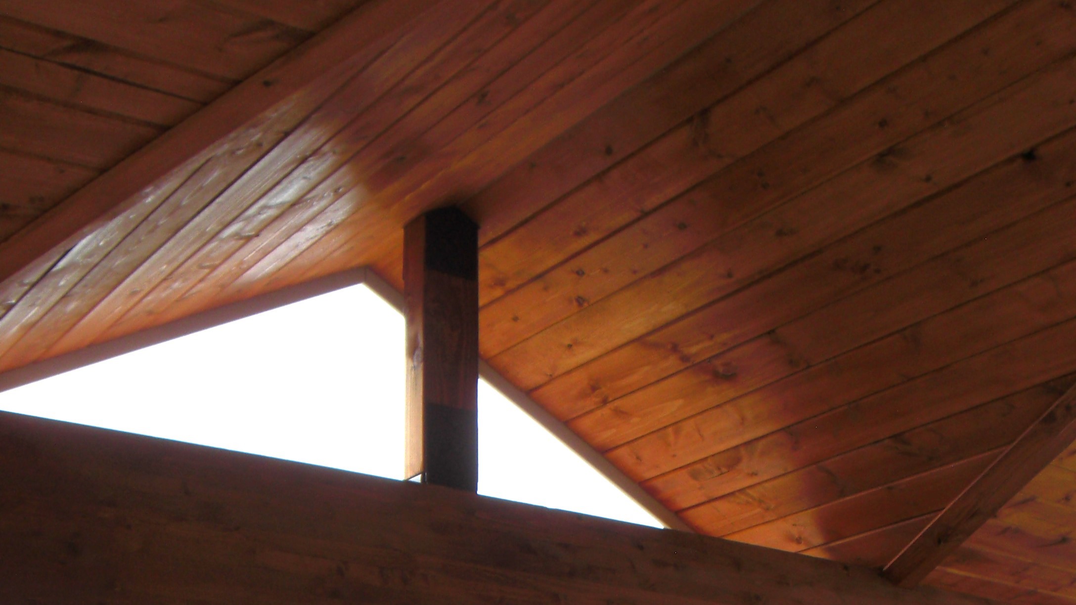 Peaked shed roof deck cover with a closed ceiling in tongue and groove knotty pine