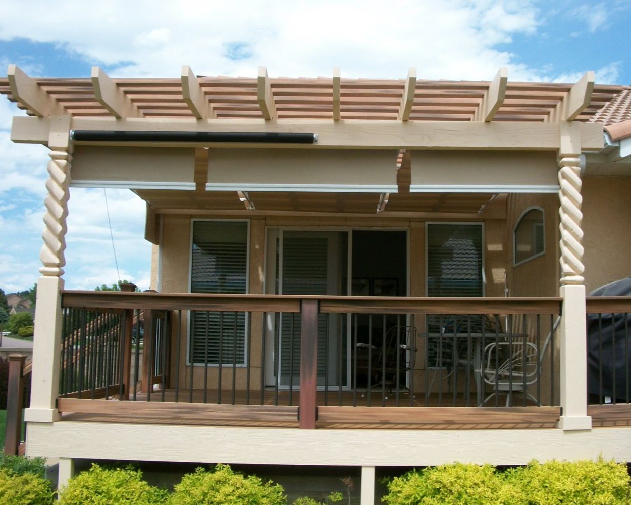 A composite deck with pergola featuring partially twisted support beams.